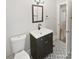 Elegant bathroom features a black vanity, modern fixtures, and patterned floor tiles at 3109 Morson St, Charlotte, NC 28208