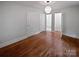 Spacious bedroom with hardwood floors and access to a bathroom through a doorway at 3109 Morson St, Charlotte, NC 28208