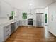 Modern kitchen featuring stainless steel appliances, white cabinets, and hardwood floors at 3109 Morson St, Charlotte, NC 28208