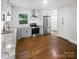 This kitchen features stainless steel appliances, white cabinets, and hardwood floors at 3109 Morson St, Charlotte, NC 28208