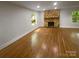 Sunlit living room boasts a stone fireplace and hardwood floors at 3109 Morson St, Charlotte, NC 28208