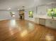 Open-concept living area with stone fireplace flows into the kitchen at 3109 Morson St, Charlotte, NC 28208