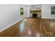 Spacious living room with hardwood floors and stone fireplace, offering a bright and airy atmosphere at 3109 Morson St, Charlotte, NC 28208