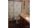 Well-lit bathroom featuring a single sink vanity and shower with decorative curtain at 315 S Grandview Rd, Clover, SC 29710