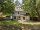 Backyard view of the home, showing lawn, shed and mature trees at 3313 Fortis Ln, Matthews, NC 28105