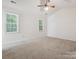 Spacious bedroom with two windows, ceiling fan, and neutral carpet at 3313 Fortis Ln, Matthews, NC 28105