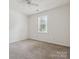 Bedroom with neutral carpet, window and ceiling fan at 3313 Fortis Ln, Matthews, NC 28105