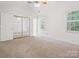 Bedroom with natural light, mirrored closet doors, and neutral carpet at 3313 Fortis Ln, Matthews, NC 28105