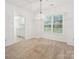 Light-filled dining room with neutral carpet and view to kitchen through doorway at 3313 Fortis Ln, Matthews, NC 28105