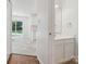 View from hallway into kitchen and eating area with sliding glass door to the yard at 3313 Fortis Ln, Matthews, NC 28105