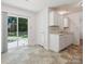 Sunny kitchen area boasts white cabinets and sliding glass door to the backyard at 3313 Fortis Ln, Matthews, NC 28105