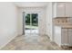 Bright kitchen area with backyard access via sliding glass door and adjacent doorway at 3313 Fortis Ln, Matthews, NC 28105