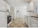 Spacious kitchen with white cabinets and appliances, and access to the back door at 3313 Fortis Ln, Matthews, NC 28105