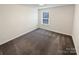 An open carpeted bedroom with a window that lets in natural light at 3486 Duchess Ave, Fort Mill, SC 29707