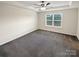 A bright bedroom with tray ceilings, a large window, carpeted floors, and a ceiling fan with lighting at 3486 Duchess Ave, Fort Mill, SC 29707