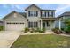 Charming two-story home with a well-manicured lawn, attached two-car garage, and inviting front porch at 3486 Duchess Ave, Fort Mill, SC 29707