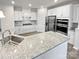 Modern kitchen with stainless appliances, white cabinetry, and gray granite countertops at 3486 Duchess Ave, Fort Mill, SC 29707