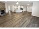 Spacious open floor plan with fireplace and kitchen featuring an island offering a welcoming atmosphere at 3486 Duchess Ave, Fort Mill, SC 29707