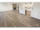 Spacious open floor plan with wood flooring, a fireplace, and a kitchen island, offering a modern feel at 3486 Duchess Ave, Fort Mill, SC 29707