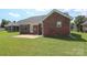 Charming brick home features a spacious backyard with a concrete patio, perfect for outdoor entertaining at 3523 Brickwood Cir, Midland, NC 28107