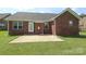 Back of brick home with patio and green lawn at 3523 Brickwood Cir, Midland, NC 28107