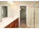 Well lit bathroom featuring double vanity and glass door shower at 3523 Brickwood Cir, Midland, NC 28107