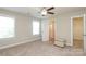 Bright bedroom with carpet flooring, ceiling fan, and access to a bathroom and closet at 3523 Brickwood Cir, Midland, NC 28107