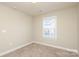 A well-lit bedroom featuring neutral walls, carpet flooring, and a window allowing natural light at 3523 Brickwood Cir, Midland, NC 28107