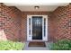 Inviting front entrance featuring brick facade, classic black door with sidelights and a 'Welcome' mat at 3523 Brickwood Cir, Midland, NC 28107