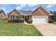 Charming single-story red brick home featuring manicured lawn, tasteful landscaping and a two car garage at 3523 Brickwood Cir, Midland, NC 28107