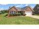 Charming single-story red brick home featuring manicured lawn, tasteful landscaping and a two car garage at 3523 Brickwood Cir, Midland, NC 28107
