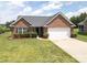 Charming single-story brick home with well-maintained landscaping, a two-car garage, and a welcoming entrance at 3523 Brickwood Cir, Midland, NC 28107