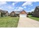 Charming brick home with well-manicured front yard and a spacious driveway leading to a two-car garage at 3523 Brickwood Cir, Midland, NC 28107