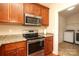 Close up of the kitchen appliances with a door leading to the laundry area at 3523 Brickwood Cir, Midland, NC 28107