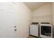 Functional laundry room with modern washer and dryer units and ample space at 3523 Brickwood Cir, Midland, NC 28107
