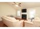 Bright living room featuring hardwood floors, fireplace, neutral walls, and lots of natural light at 3523 Brickwood Cir, Midland, NC 28107