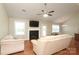 Cozy living room featuring a fireplace, hardwood floors, neutral paint and a ceiling fan at 3523 Brickwood Cir, Midland, NC 28107
