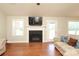 Bright living room featuring hardwood floors, fireplace, neutral walls, and lots of natural light at 3523 Brickwood Cir, Midland, NC 28107