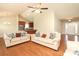 Open concept living room featuring hardwood floors, neutral walls, and views of the kitchen at 3523 Brickwood Cir, Midland, NC 28107