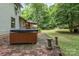 Backyard with hot tub, patio, deck, and lush greenery at 3884 Snider Cir, Hickory, NC 28602