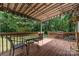 Backyard deck features patio table with string lights and wooded views at 3884 Snider Cir, Hickory, NC 28602