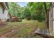 Large backyard with lush greenery, deck, hot tub and wooded views at 3884 Snider Cir, Hickory, NC 28602