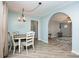 Dining room features natural light, wood floors, a charming chandelier, and a view to the living room at 3884 Snider Cir, Hickory, NC 28602