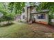 Home featuring a two-car garage, stone accents, mature landscaping, and a cozy covered porch at 3884 Snider Cir, Hickory, NC 28602