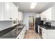 A functional kitchen is equipped with white cabinets, modern appliances, and granite counters at 3884 Snider Cir, Hickory, NC 28602