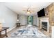 Bright living room boasts a stone fireplace, ceiling fan, and a large window providing natural light at 3884 Snider Cir, Hickory, NC 28602
