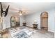 Open-concept living room features a stone fireplace, neutral walls, wood-look floors, and arched doorways at 3884 Snider Cir, Hickory, NC 28602