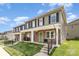 Charming townhouse featuring stone accents, a welcoming front porch, and well-manicured lawn at 3965 Hemingway Dr, Hickory, NC 28601