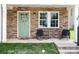 Inviting front porch with stylish chairs and a decorative wreath on the charming green door at 3965 Hemingway Dr, Hickory, NC 28601