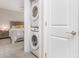 A modern, white, stacked washer and dryer are conveniently located within a closet near the bedroom at 3965 Hemingway Dr, Hickory, NC 28601